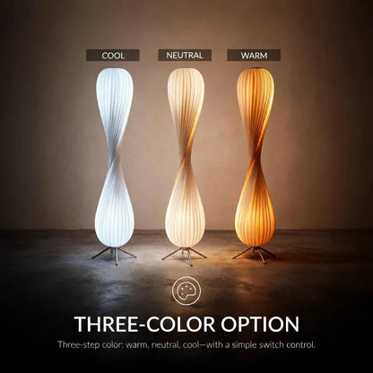 Three modern floor lamps with cool, neutral, and warm light options on a plain background.